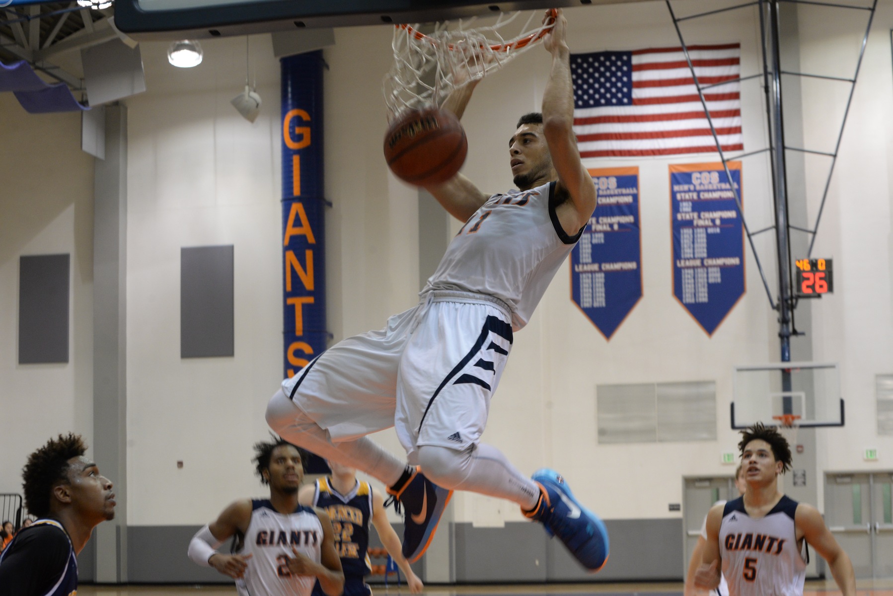 COS forward Kentrey Bynum hanging on the rim on a dunk.